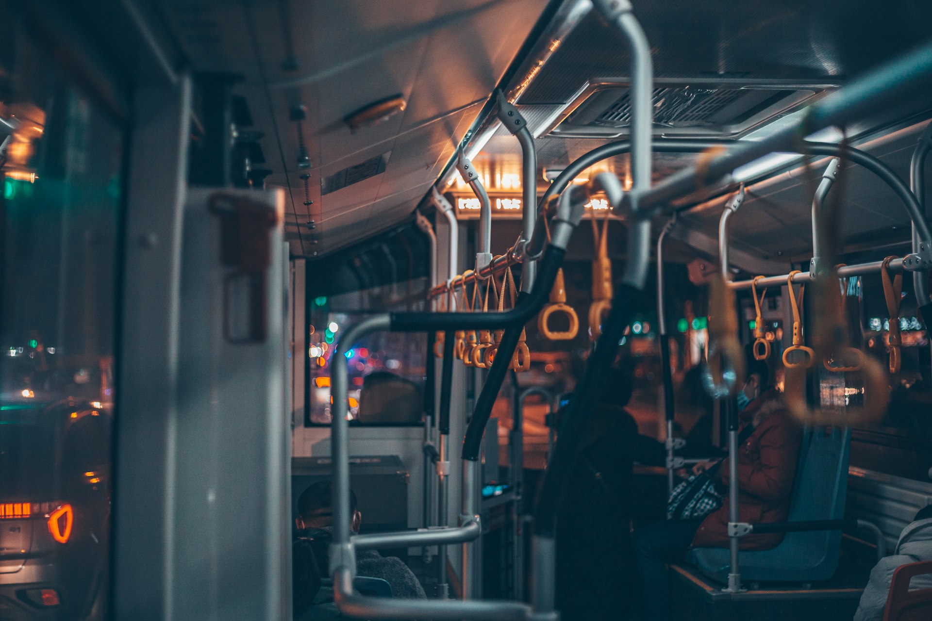 man in black jacket standing in train